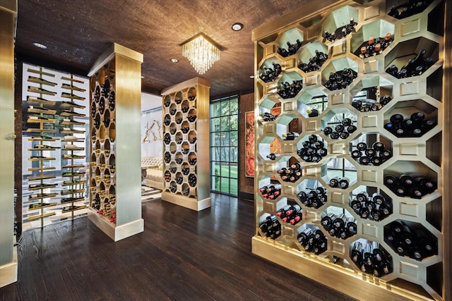 2307 River Oaks Blvd, Houston, TX 77019 - wine cellar with wood finished floors, a chandelier, and baseboards