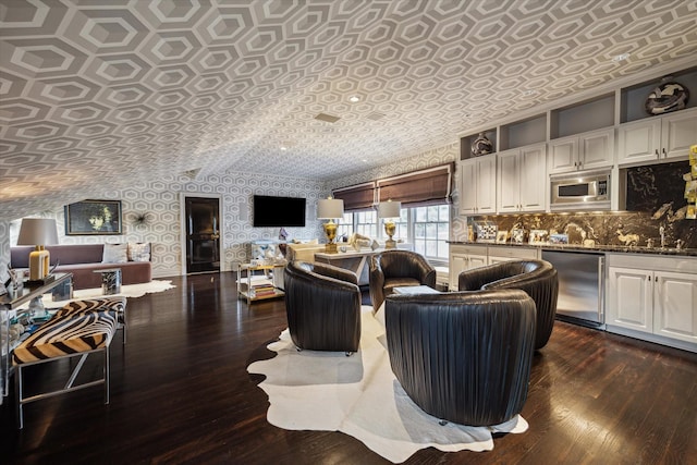 2307 River Oaks Blvd, Houston, TX 77019 - living area featuring wallpapered walls, dark wood-style floors, and an ornate ceiling