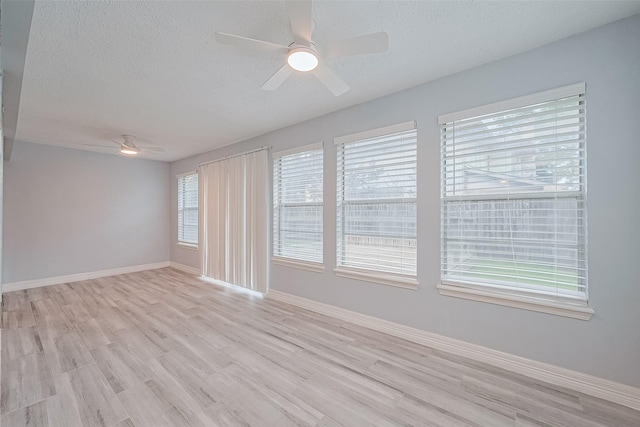 2115 Streamcrest Ln, Sugar Land, TX 77479 - empty room featuring ceiling fan, light wood-style floors, a textured ceiling, and baseboards