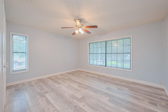 2115 Streamcrest Ln, Sugar Land, TX 77479 - spare room with healthy amount of natural light, ceiling fan, a textured ceiling, and light wood-style flooring
