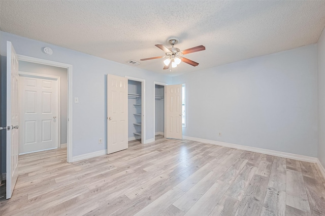 2115 Streamcrest Ln, Sugar Land, TX 77479 - unfurnished bedroom featuring light wood-type flooring, a closet, baseboards, and a textured ceiling