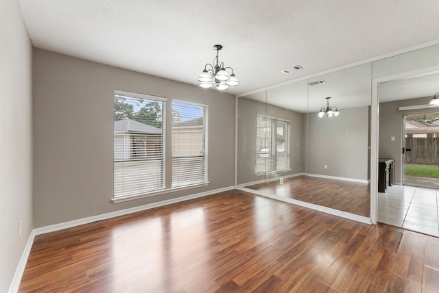 4807 Wind Chimes Dr, Houston, TX 77066 - empty room with a chandelier, wood finished floors, and plenty of natural light