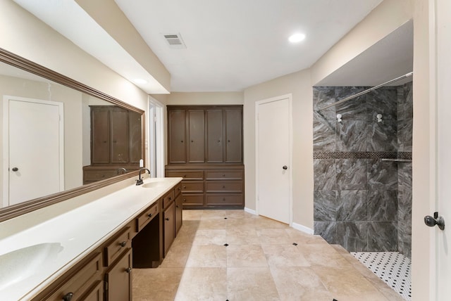 4807 Wind Chimes Dr, Houston, TX 77066 - full bathroom with double vanity, tiled shower, recessed lighting, and baseboards