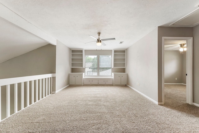 4807 Wind Chimes Dr, Houston, TX 77066 - spare room featuring attic access, a ceiling fan, a textured ceiling, carpet, and baseboards