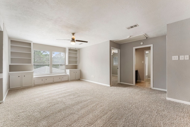 4807 Wind Chimes Dr, Houston, TX 77066 - unfurnished bedroom with attic access, a textured ceiling, carpet floors, baseboards, and ceiling fan