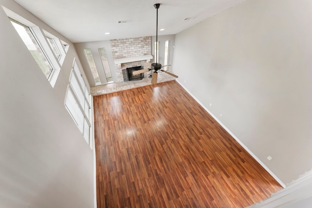 4807 Wind Chimes Dr, Houston, TX 77066 - unfurnished living room featuring baseboards, wood finished floors, and a brick fireplace