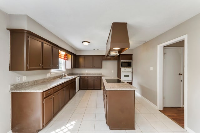 4807 Wind Chimes Dr, Houston, TX 77066 - kitchen with white oven, a sink, stainless steel microwave, a kitchen island with sink, and light countertops