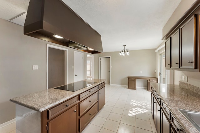 4807 Wind Chimes Dr, Houston, TX 77066 - kitchen with black electric stovetop, premium range hood, a chandelier, light tile patterned floors, and a kitchen island