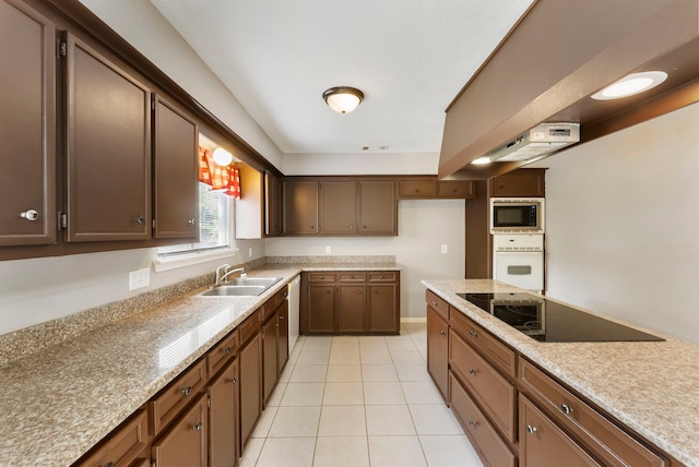 4807 Wind Chimes Dr, Houston, TX 77066 - kitchen featuring white oven, a sink, black electric cooktop, stainless steel microwave, and light tile patterned flooring
