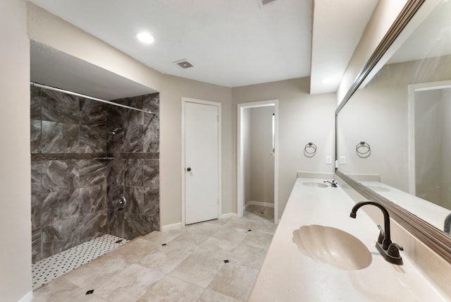 4807 Wind Chimes Dr, Houston, TX 77066 - bathroom with a tile shower, double vanity, recessed lighting, and baseboards