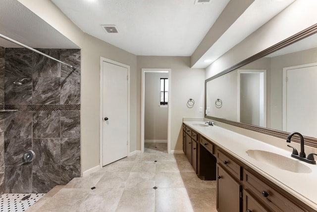 4807 Wind Chimes Dr, Houston, TX 77066 - bathroom featuring double vanity, tiled shower, and baseboards