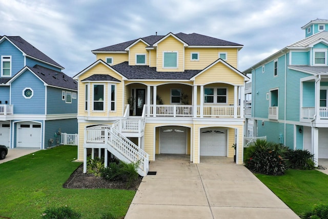 4115 Sand Hill Ct, Galveston, TX 77554 - coastal home featuring an attached garage, roof with shingles, stairs, a front lawn, and a porch