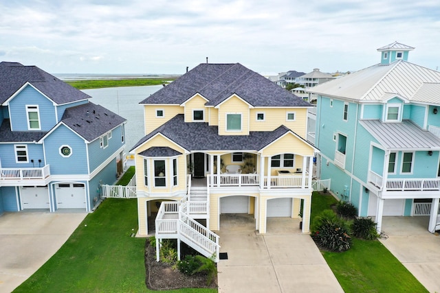 4115 Sand Hill Ct, Galveston, TX 77554 - raised beach house featuring a garage, driveway, and a porch