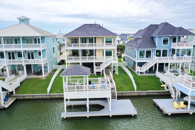 4115 Sand Hill Ct, Galveston, TX 77554 - back of property with a water view, a lawn, a residential view, and a gazebo