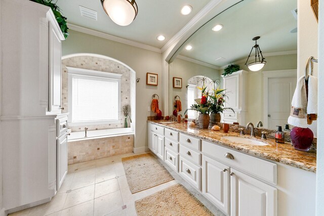 4115 Sand Hill Ct, Galveston, TX 77554 - bathroom featuring double vanity, a bath, tile patterned flooring, crown molding, and recessed lighting