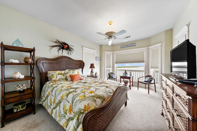 4115 Sand Hill Ct, Galveston, TX 77554 - bedroom with light carpet and a ceiling fan