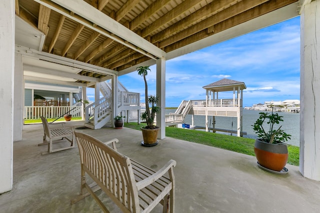 4115 Sand Hill Ct, Galveston, TX 77554 - view of patio / terrace with stairway, a water view, boat lift, and a boat dock