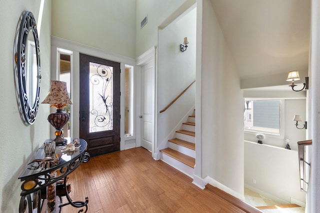 4115 Sand Hill Ct, Galveston, TX 77554 - entryway featuring light wood-style flooring and a high ceiling