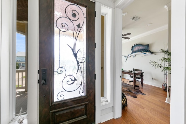 4115 Sand Hill Ct, Galveston, TX 77554 - entrance foyer with ornamental molding, wood finished floors, baseboards, and a ceiling fan