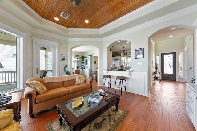 4115 Sand Hill Ct, Galveston, TX 77554 - living room with arched walkways, wooden ceiling, wood finished floors, ornamental molding, and a raised ceiling