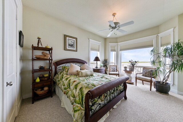 4115 Sand Hill Ct, Galveston, TX 77554 - bedroom featuring light carpet, baseboards, and ceiling fan