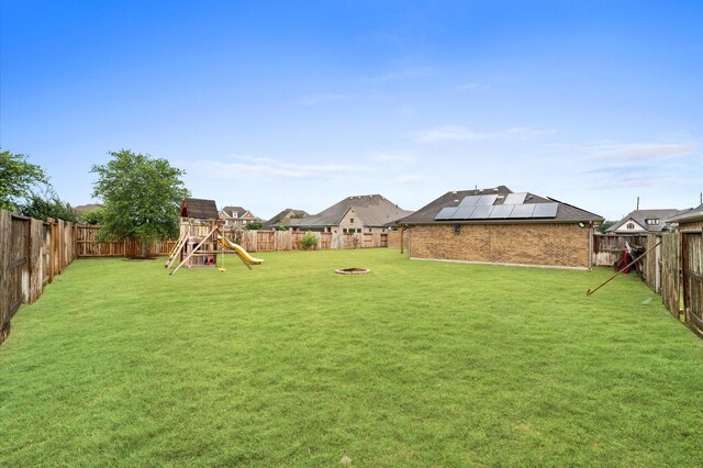 10110 Da Vinci Ct, Iowa Colony, TX 77583 - view of yard featuring a playground and an outdoor fire pit