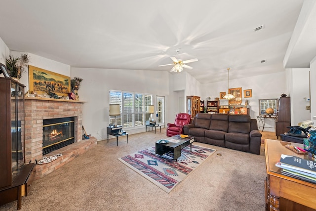 125 Terrace Ln E, Kerrville, TX 78028 - carpeted living room featuring a brick fireplace, ceiling fan, lofted ceiling, and a chandelier