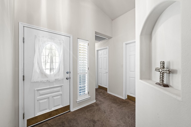 125 Terrace Ln E, Kerrville, TX 78028 - entryway with dark colored carpet, high vaulted ceiling, and baseboards