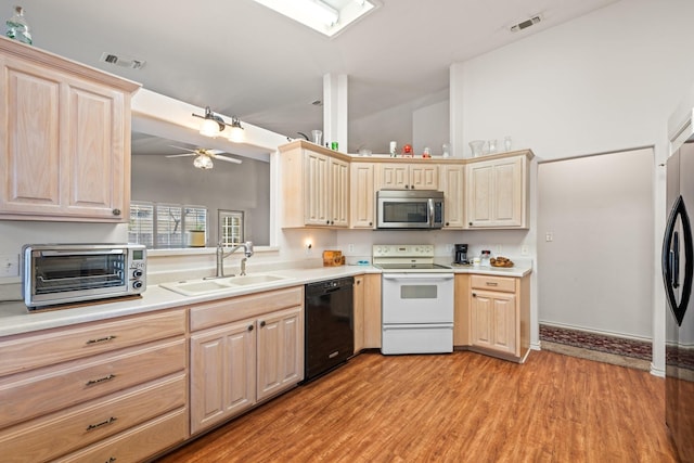 125 Terrace Ln E, Kerrville, TX 78028 - kitchen featuring white electric range oven, stainless steel microwave, black dishwasher, a sink, and light brown cabinetry