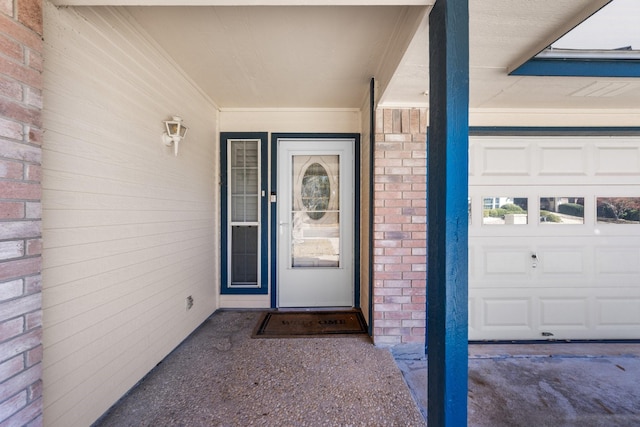 125 Terrace Ln E, Kerrville, TX 78028 - view of exterior entry with a garage and brick siding