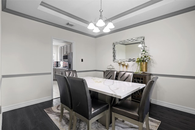 14314 Strutton Dr, Sugar Land, TX 77498 - dining area featuring a chandelier, a tray ceiling, dark wood finished floors, baseboards, and crown molding