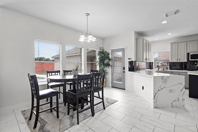 14314 Strutton Dr, Sugar Land, TX 77498 - dining area featuring plenty of natural light, a chandelier, recessed lighting, and light marble finish flooring
