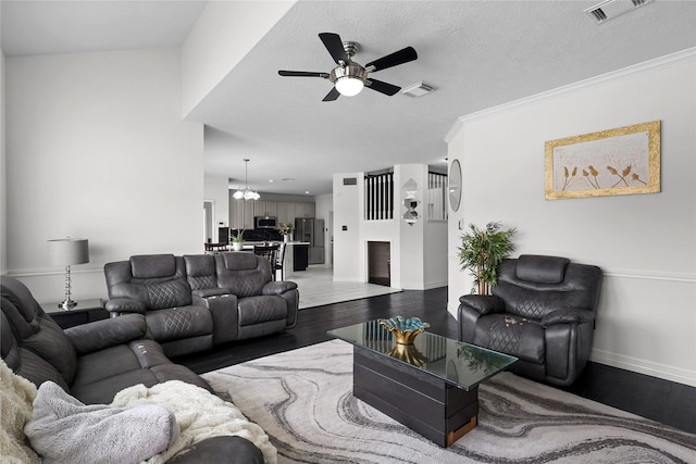 14314 Strutton Dr, Sugar Land, TX 77498 - living area with dark wood-style floors, a ceiling fan, baseboards, a chandelier, and ornamental molding