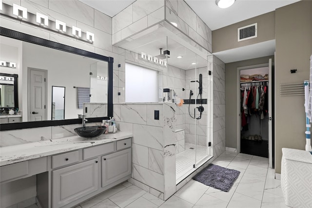 14314 Strutton Dr, Sugar Land, TX 77498 - full bathroom with marble look tiles, a stall shower, and vanity