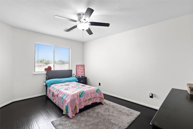 14314 Strutton Dr, Sugar Land, TX 77498 - bedroom featuring baseboards, a ceiling fan, a textured ceiling, and dark wood-style flooring