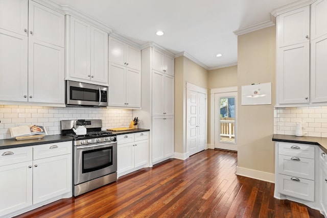 807 Vincent St, Houston, TX 77009 - kitchen featuring appliances with stainless steel finishes, dark countertops, baseboards, crown molding, and dark wood-style floors