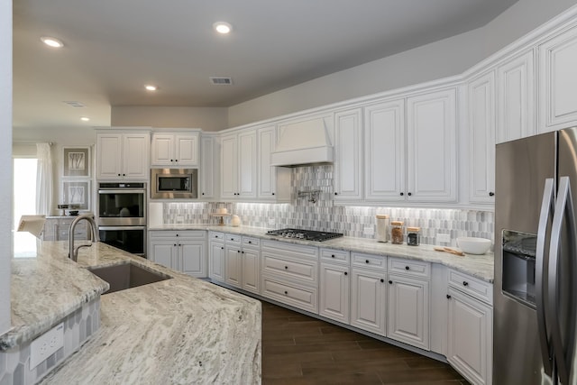 17333 July Moon Ln, Conroe, TX 77302 - kitchen with appliances with stainless steel finishes, a sink, white cabinets, backsplash, and recessed lighting