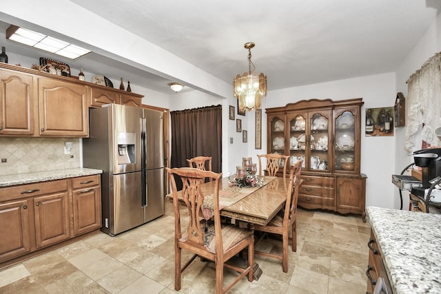 1110 E Brown Ln, Deer Park, TX 77536 - dining area with a chandelier and light stone finish flooring