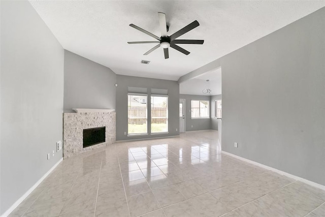 1211 Peacham Ct, Fresno, TX 77545 - unfurnished living room featuring a ceiling fan, light tile patterned floors, a fireplace, and baseboards