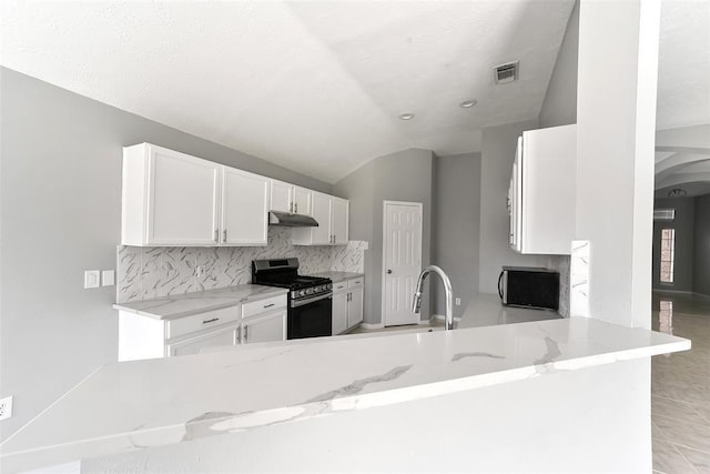 1211 Peacham Ct, Fresno, TX 77545 - kitchen featuring stainless steel range with gas cooktop, under cabinet range hood, white cabinets, light stone countertops, and lofted ceiling