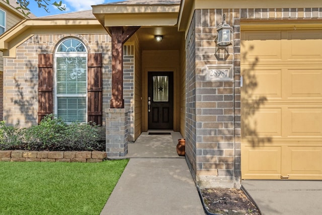 28987 Birch Green Way, Spring, TX 77386 - view of exterior entry with brick siding and a garage