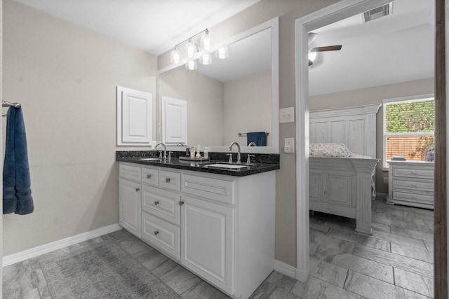 28987 Birch Green Way, Spring, TX 77386 - bathroom featuring double vanity, ceiling fan, baseboards, and marble look tile flooring