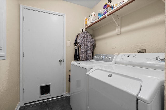 28987 Birch Green Way, Spring, TX 77386 - laundry room featuring independent washer and dryer, dark tile patterned floors, and baseboards