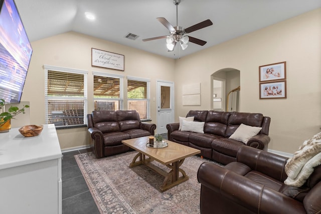 28987 Birch Green Way, Spring, TX 77386 - living room with arched walkways, ceiling fan, lofted ceiling, baseboards, and dark tile patterned flooring