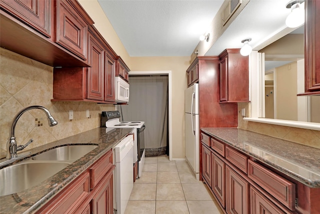 11550 Chimney Rock Rd Unit 324, Houston, TX 77035 - kitchen featuring a sink, white appliances, reddish brown cabinets, and decorative backsplash