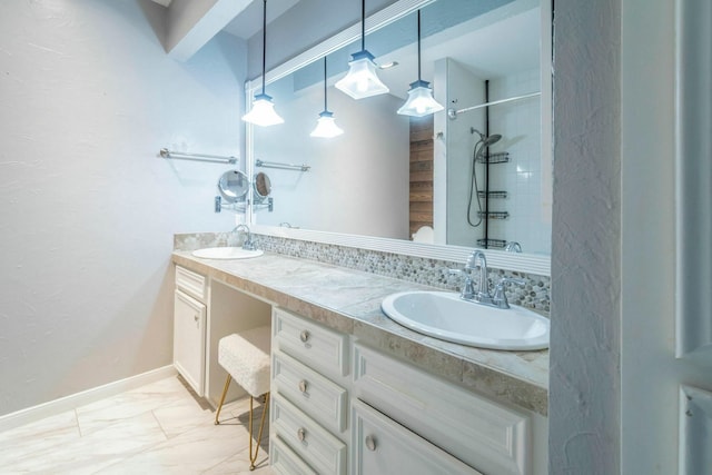 2304 Keel Ct, Willis, TX 77318 - bathroom with double vanity, a tile shower, marble finish floors, and baseboards