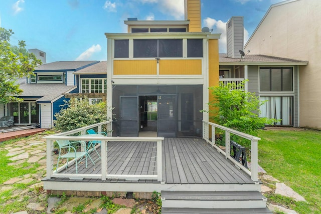 2304 Keel Ct, Willis, TX 77318 - back of house featuring a sunroom, a wooden deck, a chimney, and a lawn