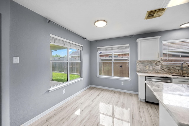 612 Hartman Dr, Baytown, TX 77521 - unfurnished dining area with a sink, baseboards, and light wood-type flooring