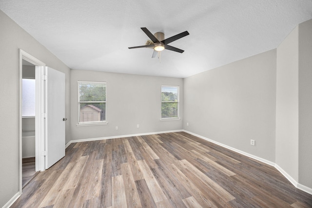 612 Hartman Dr, Baytown, TX 77521 - unfurnished bedroom with multiple windows, wood finished floors, and baseboards