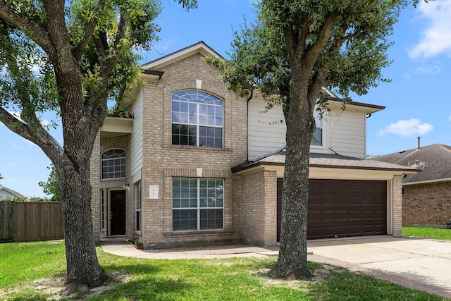 612 Hartman Dr, Baytown, TX 77521 - traditional-style house featuring an attached garage, brick siding, and driveway